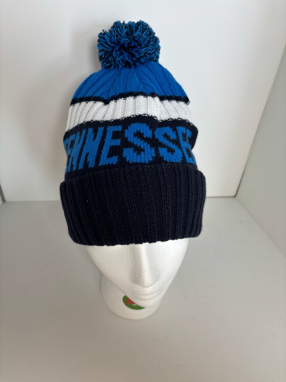 Tennessee Titans blue, white, and navy blue striped knit beanie with pom pom
